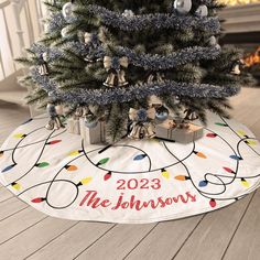 a christmas tree with presents under it on the floor