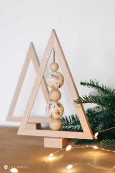 a christmas tree made out of wood and balls with text overlay that reads dollar store trees in 10 minutes