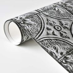 a black and white wallpaper with an ornate design on the bottom half of it