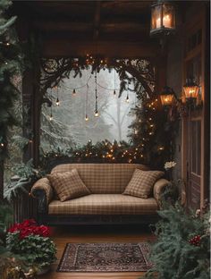 a couch sitting on top of a wooden floor covered in christmas lights and greenery