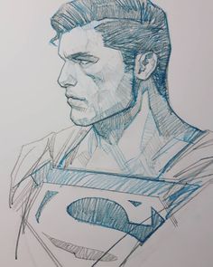 a drawing of superman in blue and white ink on paper with the image of his face drawn