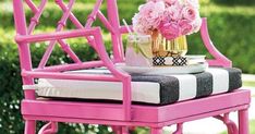 a pink chair with flowers on top of it