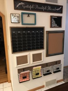 a wall with several frames and pictures on it