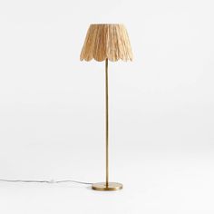 the floor lamp is made out of wood and has a large shade on it's base