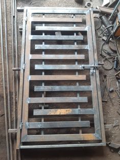 a metal grate sitting on top of a floor next to other tools and equipment