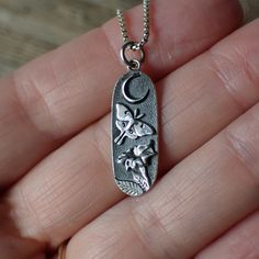 Immerse yourself in the enchanting world of the night sky with this intricately crafted pendant, thoughtfully fashioned from recycled sterling silver to align with our commitment to sustainable elegance.Measuring 23mm in length and 9mm in width, this charm encapsulates the grace of a luna moth as it flutters under the moon's gentle glow, nestled amidst the petals of a moonflower in full bloom. The details are a testament to the craftsmanship and attention to detail that went into its creation.Th Nature-inspired Moon Charm Necklace As Gift, Luna Moth Jewelry, Luna Moth Earrings, Lunar Moth Necklace, Silver Moth Earrings, Lunar Moth, Under The Moon, Luna Moth, Moon Flower