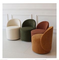 four different colored chairs sitting next to each other