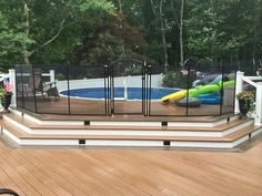 a child's bike is parked in front of a deck with a pool and slide