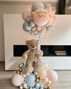 a teddy bear sitting on top of balloons