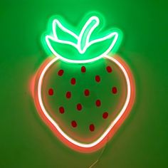 a neon sign with a strawberry on it