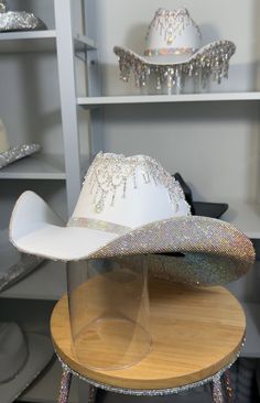 If a discount is present, it applies only to clear and clear ab stones. All other colors will have a surcharge after purchase.   I want to point out that each hat is hand-crafted. They are not without blemishes and there are no refunds as each hat is custom-made. 1) What date do you need your hat by? 2) If you know your hat size (E.g. 7 1/8) tell us. If not, watch these two YouTube videos. Measure with a SOFT tape.... Youtu.be/AwF7euDtI68 .... Youtu.be/WlDH956DMuI -Add rhinestone text for $7 per letter. Add vinyl text or logo. Price is dependent on design. Primary color= Stone color. Secondary= Hat color. Shop link for more products- www.etsy.com/shop/RhinestoneRodeo7 White Party Hat With Rhinestones, Fringe Cowgirl Hat, Rhinestone Cowboy Hat, Space Costume, Bridesmaids Outfits, Space Costumes, Wedding Country, Space Cowboys, Diy Rhinestone