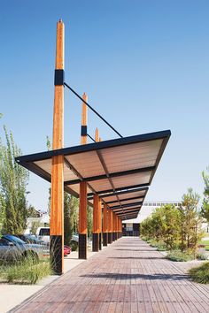 the walkway is lined with wooden posts and poles