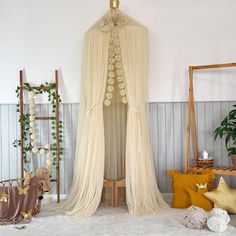 a room with several items on the floor, including a bed canopy and rugs