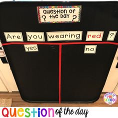 a refrigerator with magnets on it that say question of the day and are you wearing red?