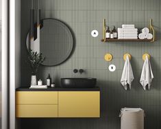 a bathroom with yellow cabinets and white towels on the rack above the sink, along with other accessories