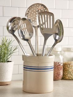 spoons and spatulas in a container on a counter