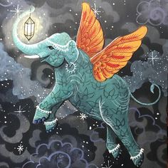 an elephant with wings and a lantern on its back