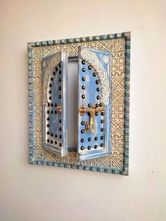 an ornate blue and white door on the wall