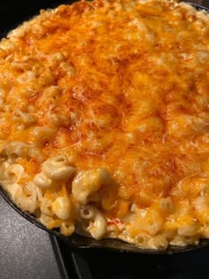 macaroni and cheese in a skillet on top of an oven burner