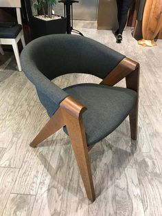 a grey chair sitting on top of a wooden floor