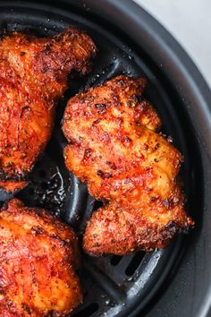 four pieces of fried chicken in an air fryer