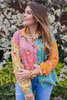 Shelby Back wears Julie Vos gold link necklaces and bracelets with a colorful spring blouse, standing in front of white flowers. Spring Edit, Gold Statement Jewelry, Colorful Gemstones, More Is More, Gold Cuffs, Gemstone Colors, Cannes