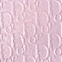 a close up view of the back side of a pink glittered paper with letters and numbers on it