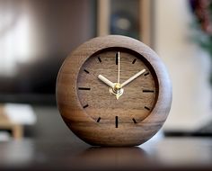 a wooden clock sitting on top of a table