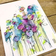 a watercolor painting of blue and pink flowers on a white paper with wood planks