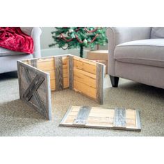 three pieces of wood sitting on the floor in front of a christmas tree