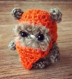 a small stuffed animal wearing an orange hat