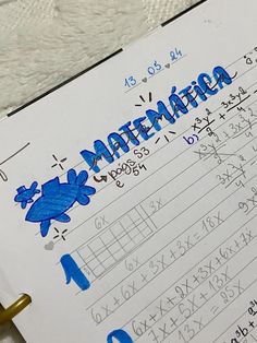 a close up of a paper with writing on it and numbers written in blue ink