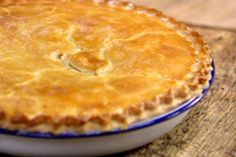 a pie sitting on top of a wooden cutting board