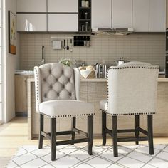 two white chairs sitting next to each other in a kitchen