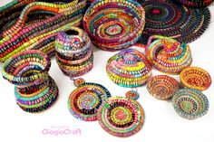 several colorful baskets are arranged on a white surface and one is made out of woven material