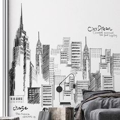 a bedroom with a city skyline drawn on the wall