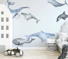 a child's bedroom decorated with whale wall decals