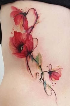 the back of a woman's stomach with flowers painted on it