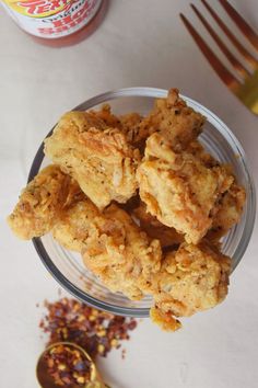 some fried food in a glass bowl on a table