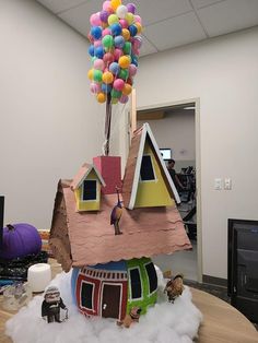 a house made out of paper and balloons