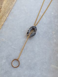 This Druzy Agate Necklace is unconventional in the BEST way! Instead of a standard end-to-end closure, this necklace is adjustable and is lengthened/shortened by crystal pull. It opens over your head, and the chain slides through the open agate and functionally adjusts to have a longer drop and tighter/looser neck! Just pull the crystal! Awesomely Adjustable! *VARIATIONS PICTURED. ORDER MIGHT NOT BE THE SAME VARIANCE AS SHOWN. *SOLD INDIVIDUALLY PRODUCT DETAILS Gold Plated, Nickel Free Curb Chai Agate Jewelry, Agate Necklace, Druzy Agate, Pendant Gold, Adjustable Necklace, Agate Pendant, Lariat Necklace, Curb Chain