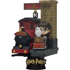 a harry potter figurine with an owl and train