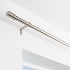 a metal pole mounted to the side of a wall next to a doorway with a door handle