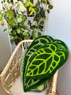 a chair covered in fake grass with a green leaf design on the seat and back