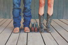 two people standing next to each other wearing cowboy boots