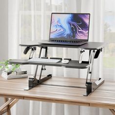 a laptop computer sitting on top of a wooden desk