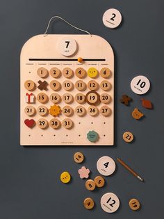 a wooden calendar with buttons and numbers on it