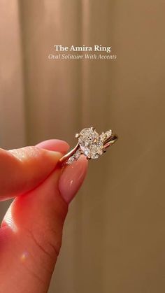 a person holding a diamond ring in their hand with the words, the annita ring