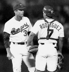 two baseball players standing next to each other