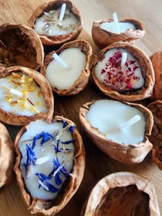 coconuts with candles in them sitting on a wooden counter top next to other items